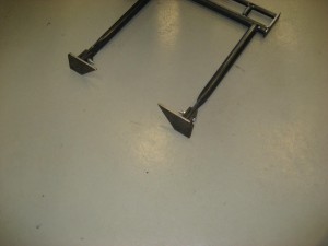 Lower arm for blade pusher